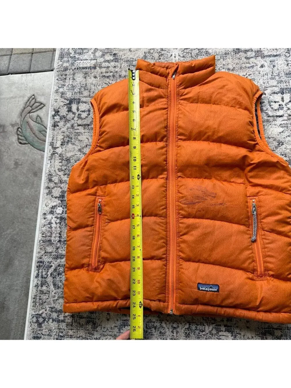 Vintage Patagonia orange puffer vest with stains